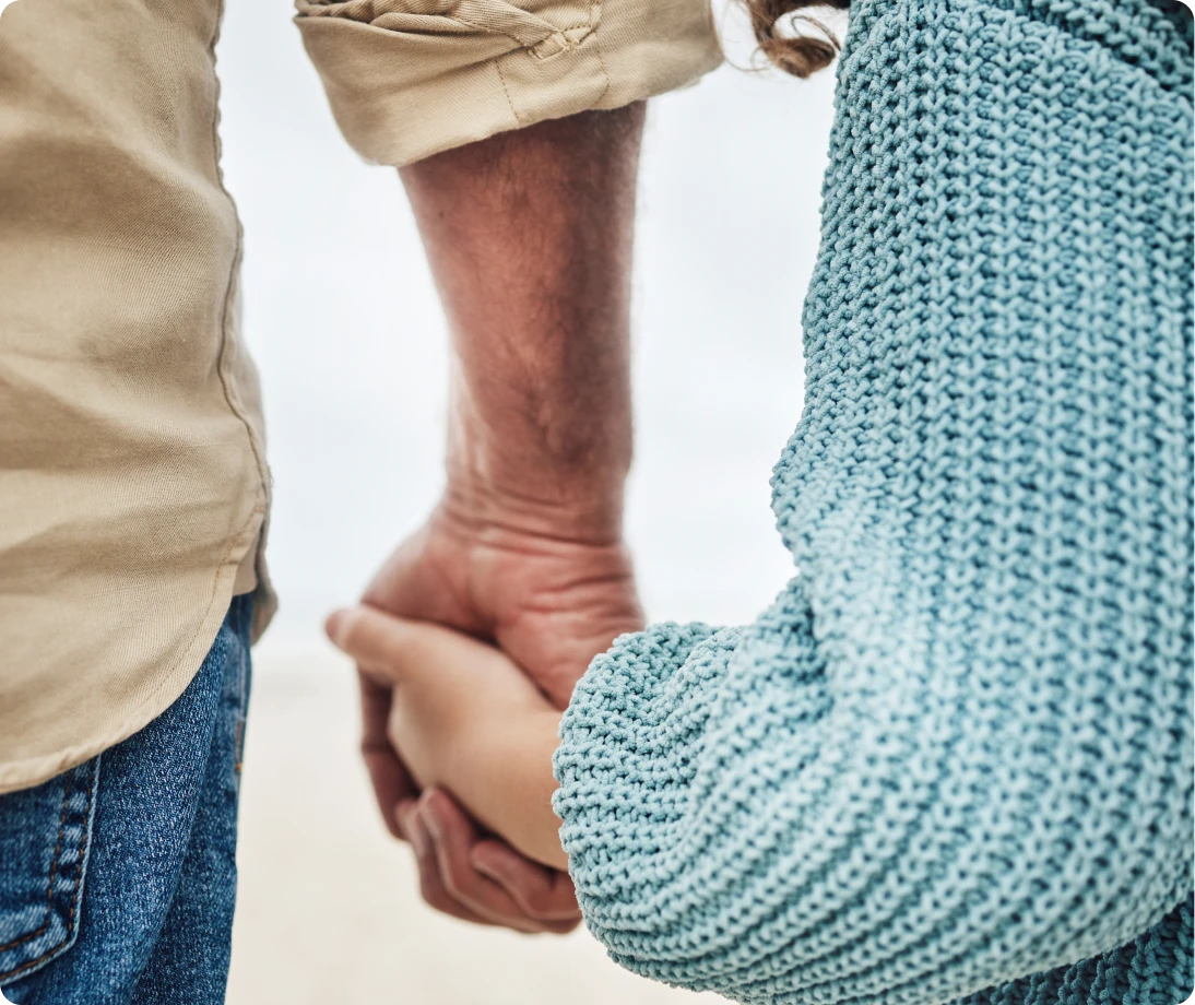 Two people holding hands tenderly